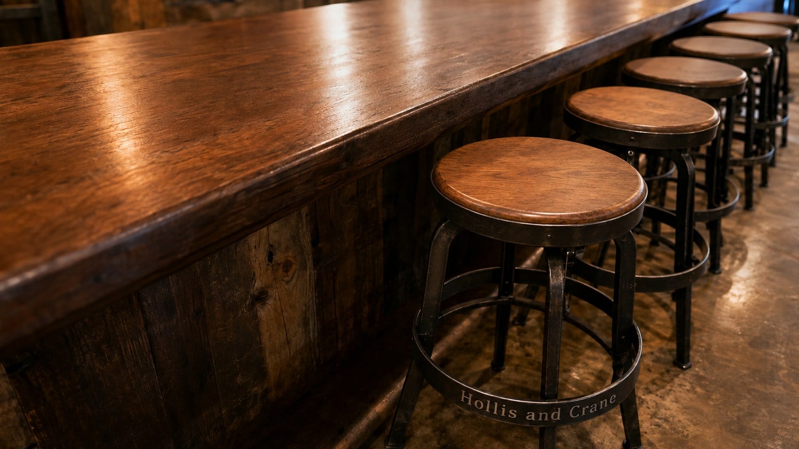 Custom branded bar stools lined up along a bar counter